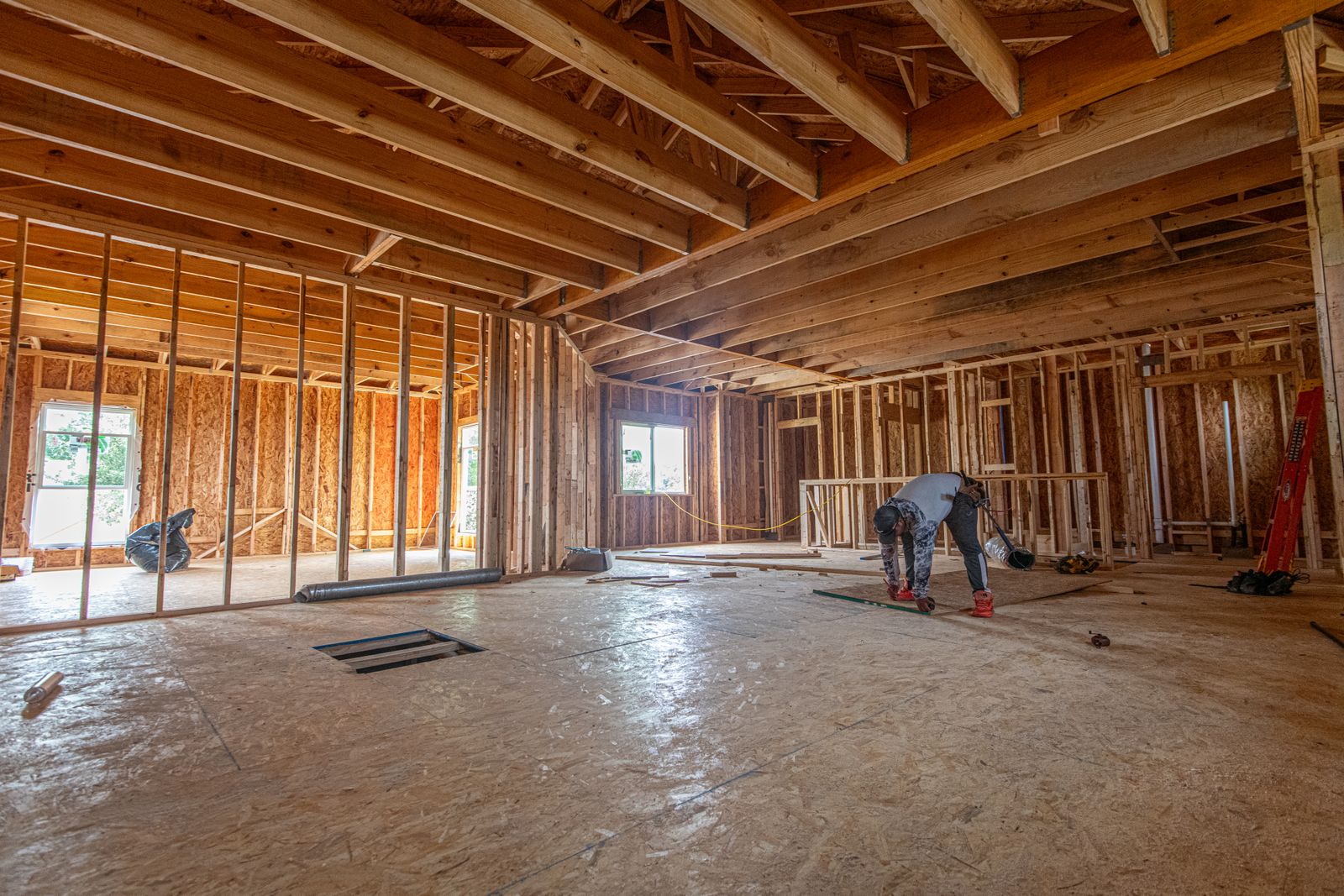 Interior of a home mid-build with framed walls and subfloor